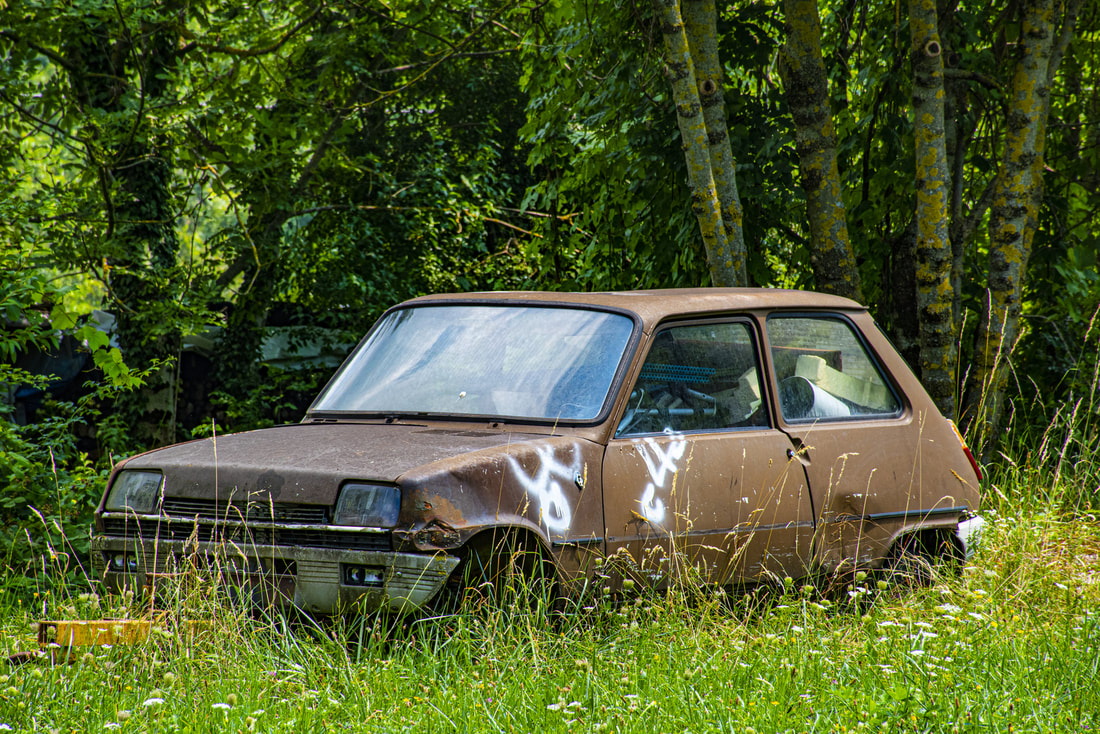 old vehicle abandoned in the forest